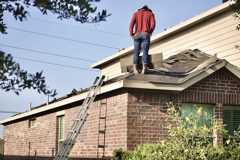 Professional roofer working on a residential roof in Hale
